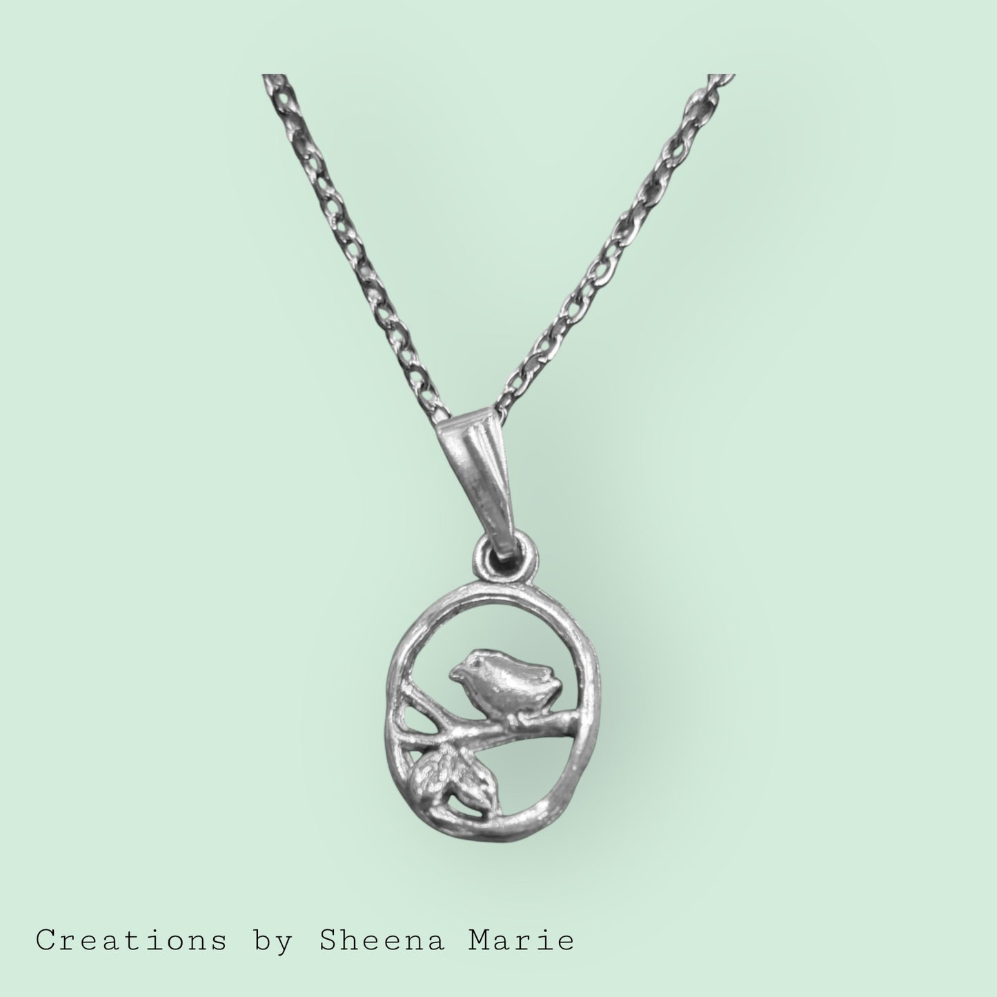 Oval Charm With Bird Perched on Branch Necklace